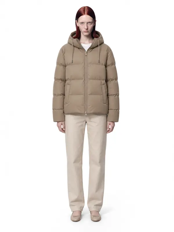 Beige puffer jacket on an AI model, white wall, front