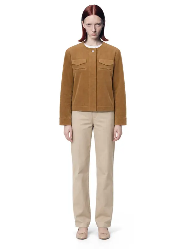 Mustard corduroy jacket on an AI model, white wall, front