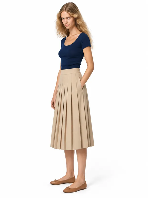 Pleated beige skirt on an AI model, white wall, three-quarter