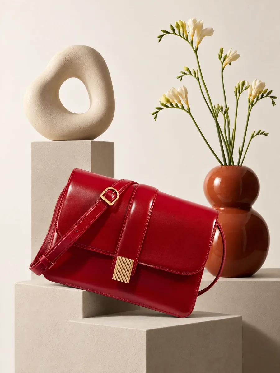 Red leather flap bag on a plinth